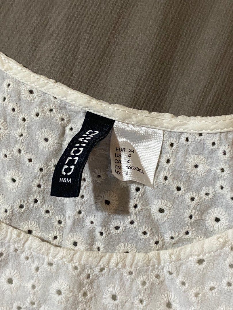 H&M Divided White Eyelet Cropped Top (Category: Blouses) located in Marikina City. Submitted by msgdptrp (Listing ID 1280733007, Image 2). Description: ‼️ AVAILABLE, ON-HAND ‼️ ‼️ LAST PRICE POSTED ‼️ – white eyelet cropped top from H&M given as a gift – size 4 (US) on tag, approximately fits SMALL – worn LESS THAN 10 TIMES – NO WHEN WORN PHOTOS – measurements (laid flat, allow 0.5 to 1" allowance): > bust: 17 3/4" > length: 17" – issue: yellowin