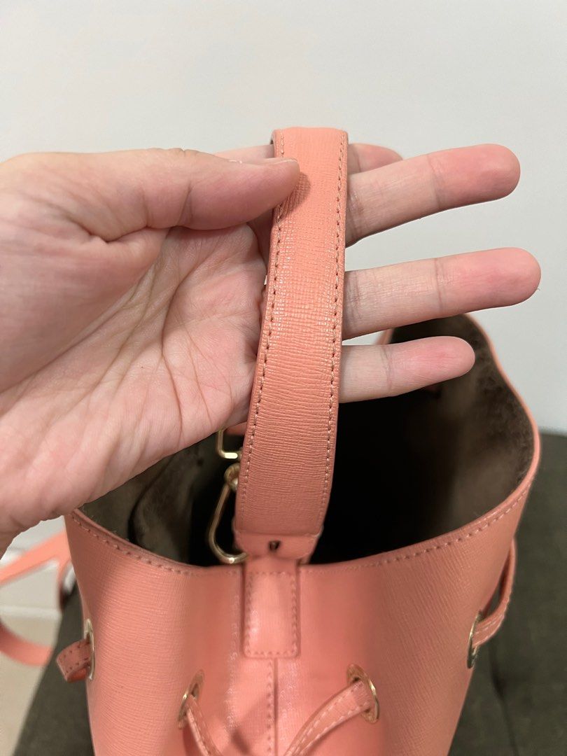 Furla Bucket Bag (Category: Cross-body Bags) located in Taguig. Submitted by prelovedjoys19 (Listing ID 1276032079, Image 2). Description: Preloved Furla Bucket Bag Color: Salmon Pink — pretty in actual! Can be worn 2-ways (handbag or crossbody bag) Comes with care card and dustbag Well used condition With minimal stains, corner rubs, cracked and bobble on suede (inside) Location: Acacia Estates, Taguig.