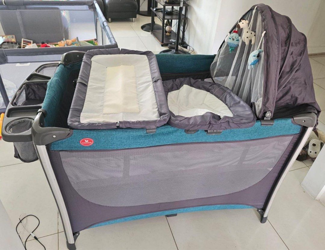 Akeeva Crib to Playpen (Category: Cots & Cribs) located in Antipolo. Submitted by olgarage888 (Listing ID 1281318599, Image 2). Description: Akeeva -Used for only 4 months - Bought for ₱12,000 - With carrier bag - With mosquito net and and toy hood - Day bed -Changing bed -Music box with light vibration -Removable mattress - Organizer caddy - Removable bottom rocker - Shipping fee to be shouldered by buyer.