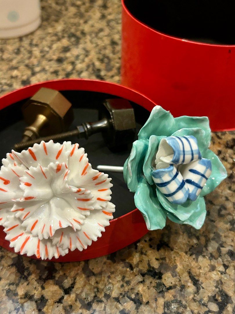 Anthropologie Knobs (Category: Other Home Decor) located in Singapore. Submitted by rathbone (Listing ID 1281283592, Image 1). Description: Flower knobs - 8 each Hexagonal knobs - 5 each All 4 for $20..