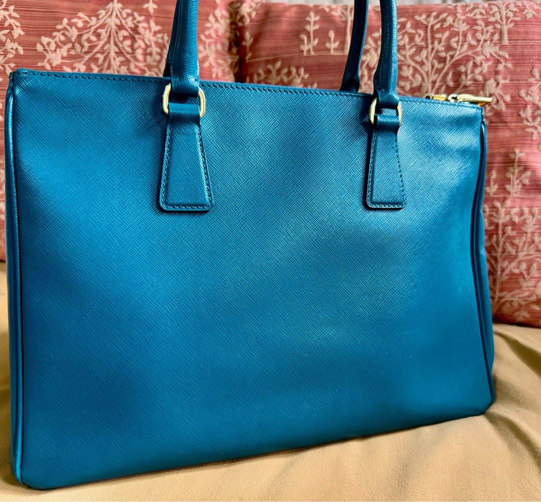 Prada Saffiano Lux Ottanio Double Zip Tote (Category: Luxury Bags & Wallets) located in Pasig City. Submitted by mr.arc (Listing ID 1281341142, Image 2). Description: Authentic Prada Saffiano Lux Double Zip Tote - inclusions as seen in picture - no box and dust bag - signs of use - slight tarnishing and hairline scratches on hardware RFS: too heavy for my mom Shipping shouldered by buyer (Metro Manila only) - grab or lalamove.