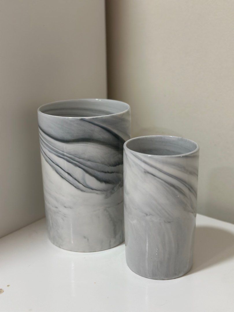 Marble vase / container (Category: Vases & Decorative Bowls) located in Cyberjaya. Submitted by syamil86 (Listing ID 1281649708, Image 1). Description: Item in super good condition Never used Measurements: Big: height 17cm, diameter 11cm Small: height 14cm, diameter 8cm.