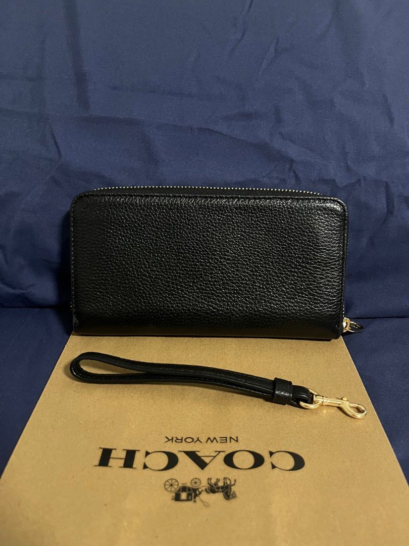 Coach Long Zip Around Wallet in Black (Category: Wallets & Card holders) located in Rizal. Submitted by pieces_mnl (Listing ID 1281981529, Image 3). Description: - Brand New - Color: Gold/Black - With Original Price Tag - With Gift Receipt for proof of authenticity - Included Coach Paper Bag Refined pebble leather 12 credit card slots Full-length bill compartments Inside zip coin pocket Zip-around closure Detachable wrist strap 7 1/2” (L) x 4” (H