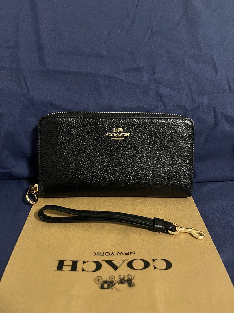 Coach Long Zip Around Wallet in Black (Category: Wallets & Card holders) located in Rizal. Submitted by pieces_mnl (Listing ID 1281981529, Image 1). Description: - Brand New - Color: Gold/Black - With Original Price Tag - With Gift Receipt for proof of authenticity - Included Coach Paper Bag Refined pebble leather 12 credit card slots Full-length bill compartments Inside zip coin pocket Zip-around closure Detachable wrist strap 7 1/2” (L) x 4” (H
