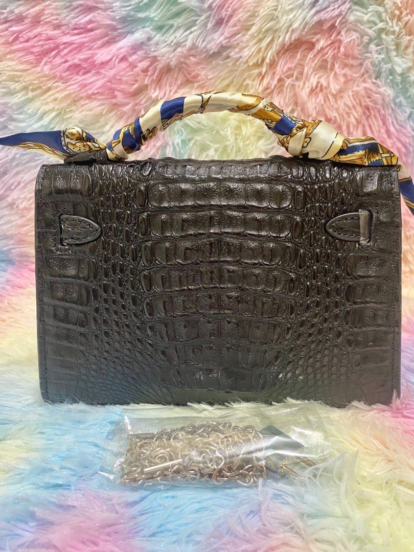 Mini Kelly Genuine Crocodile Leather (Category: Luxury Bags & Wallets) located in Makati City. Submitted by secondlyf (Listing ID 1282181128, Image 2). Description: For you exotic leather lovers out there! Discover our Mini Kelly, a beautifully crafted bag in genuine crocodile skin. Its design is sleek and logo-free, accompanied by a complimentary silver chain sling that transitions effortlessly from day to night. This bag exudes elegance in a su