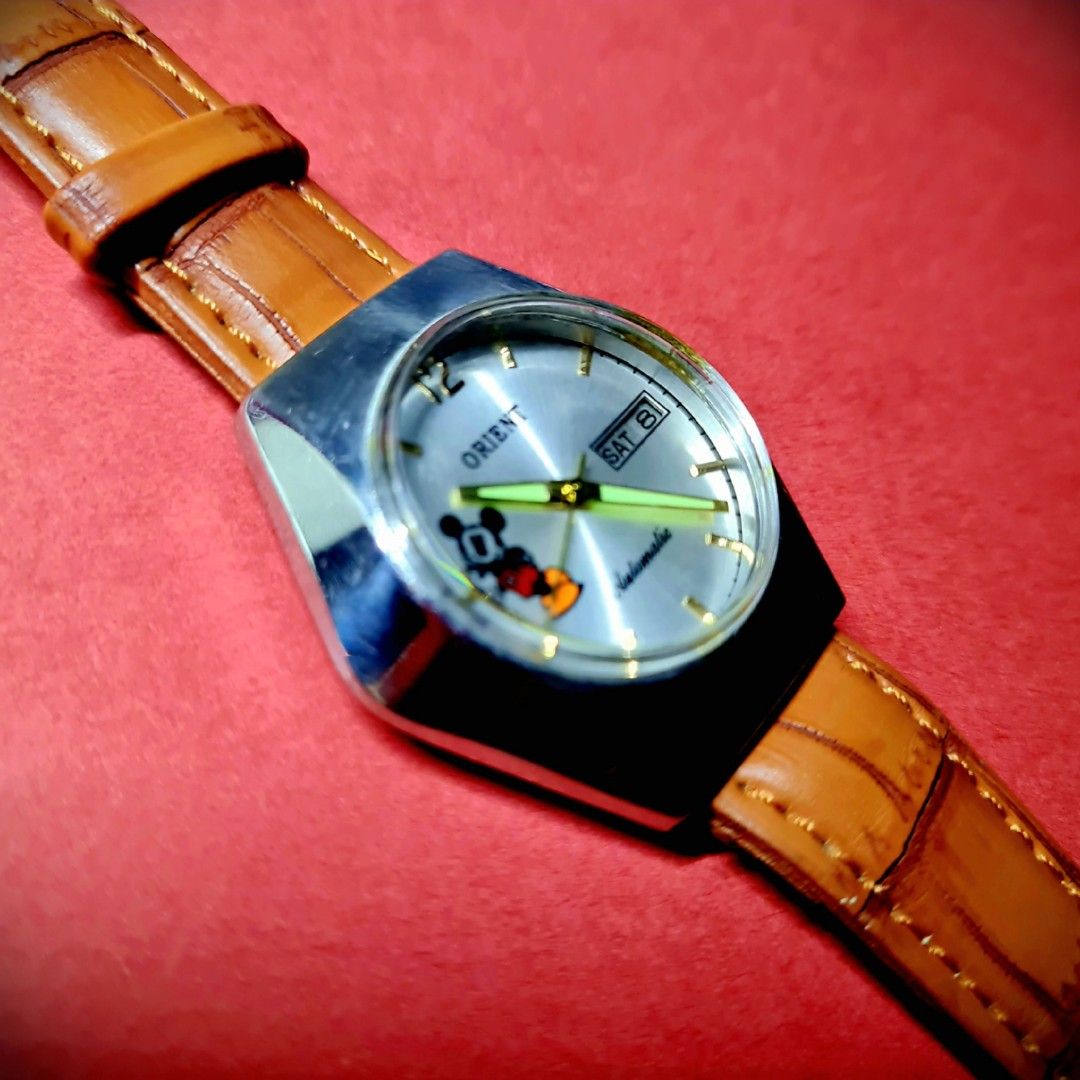 #Luxury Watch #Rare Unique #Mickey Mouse #Orient #Japan Made #Automatic (Category: Luxury Watches) located in Caloocan City. Submitted by allig8 (Listing ID 1282390680, Image 3). Description: This unique ORIENT Japanese Mickey Mouse watch boasts a stunning thick silvery case with a beautiful round shiny dial that features golden hour markers as indices. The 39mm case houses a reliable automatic movement with 21 jewels, ensuring accurate timekeepi