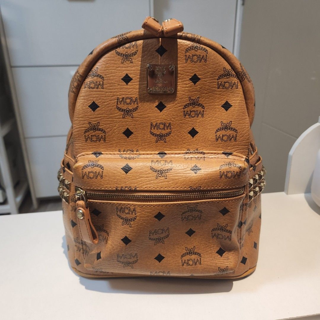 MCM Cognac Medium Studded Backpack (Category: Luxury Bags & Wallets) located in Quezon City. Submitted by castrob21 (Listing ID 1282328168, Image 1). Description: thrifted in Korea with white tag complete studs issues: oxidation in the leather and cracks.