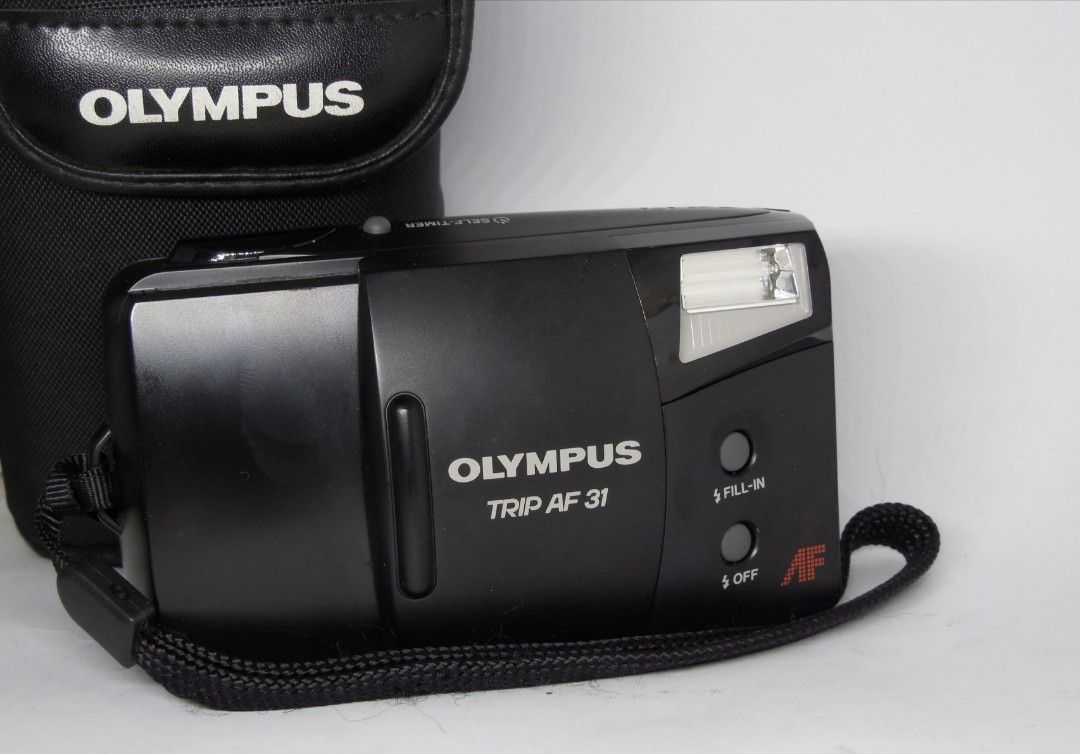 Olympus Trip AF31 (Category: Cameras) located in Las Pinas. Submitted by film101 (Listing ID 1282548415, Image 1). Description: Olympus trip AF 31 *mint condition with pouch -One of the beginner pns film camera -it's a slack and Go camera -run by AA battery 2 pcs not incl -Flash can do manually Condition of camera Electronic condition + Shutter working Flash working Timer working Film counter working AF working Shutter working Aperture snaps AF w