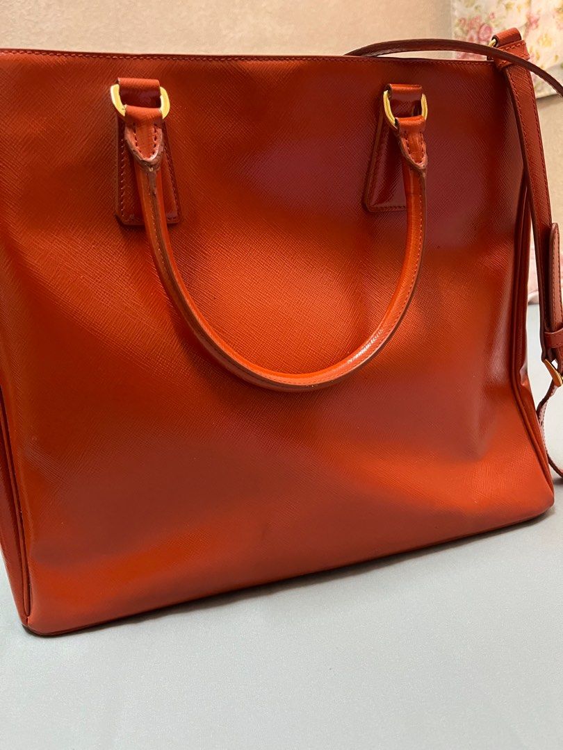 Prada Bright Orange Cross Body Tote Bag (Category: Luxury Bags & Wallets) located in Manila. Submitted by cccuyyy (Listing ID 1282451378, Image 3). Description: Authentic Bright Orange Prada Cross Body Tote Bag. An eye-catching accessory perfect for your travels. With an approximate size of 32cm W & 29cm H, it provides a sizable compartment that easily stores your every day items and more! :) cross body strap can also be adjusted..