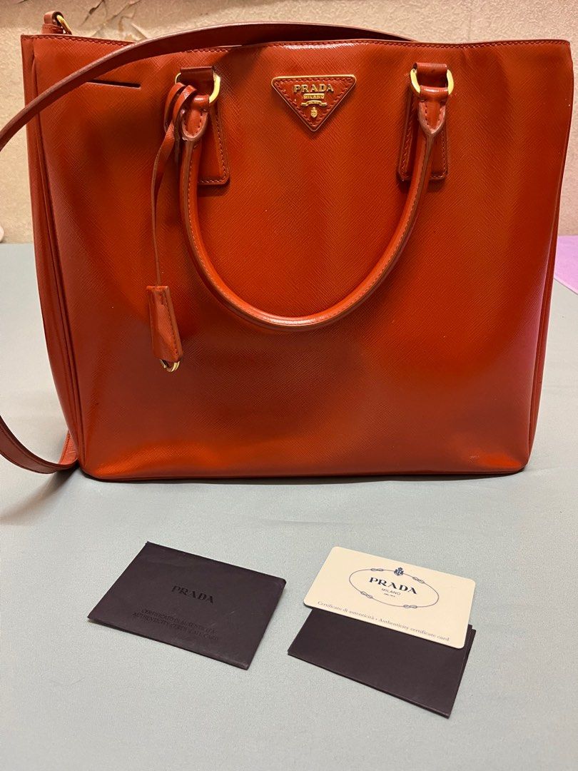 Prada Bright Orange Cross Body Tote Bag (Category: Luxury Bags & Wallets) located in Manila. Submitted by cccuyyy (Listing ID 1282451378, Image 2). Description: Authentic Bright Orange Prada Cross Body Tote Bag. An eye-catching accessory perfect for your travels. With an approximate size of 32cm W & 29cm H, it provides a sizable compartment that easily stores your every day items and more! :) cross body strap can also be adjusted..
