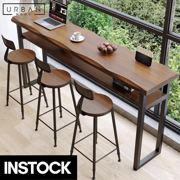 BILLY Rustic Solid Wood Bar Table (Category: Tables & Sets) located in Singapore. Submitted by collectic (Listing ID 1249307673, Image 1). Description: Shop Now: https://urbanmood.sg/products/billy-rustic-solid-wood-bar-table Redefine your bar area or outdoor lounge with our BILLY bar table. Crafted from pine wood in a beautiful matte walnut finish, its natural wavy edge adds an organic touch to your space. A convenient shelf beneath offers stora