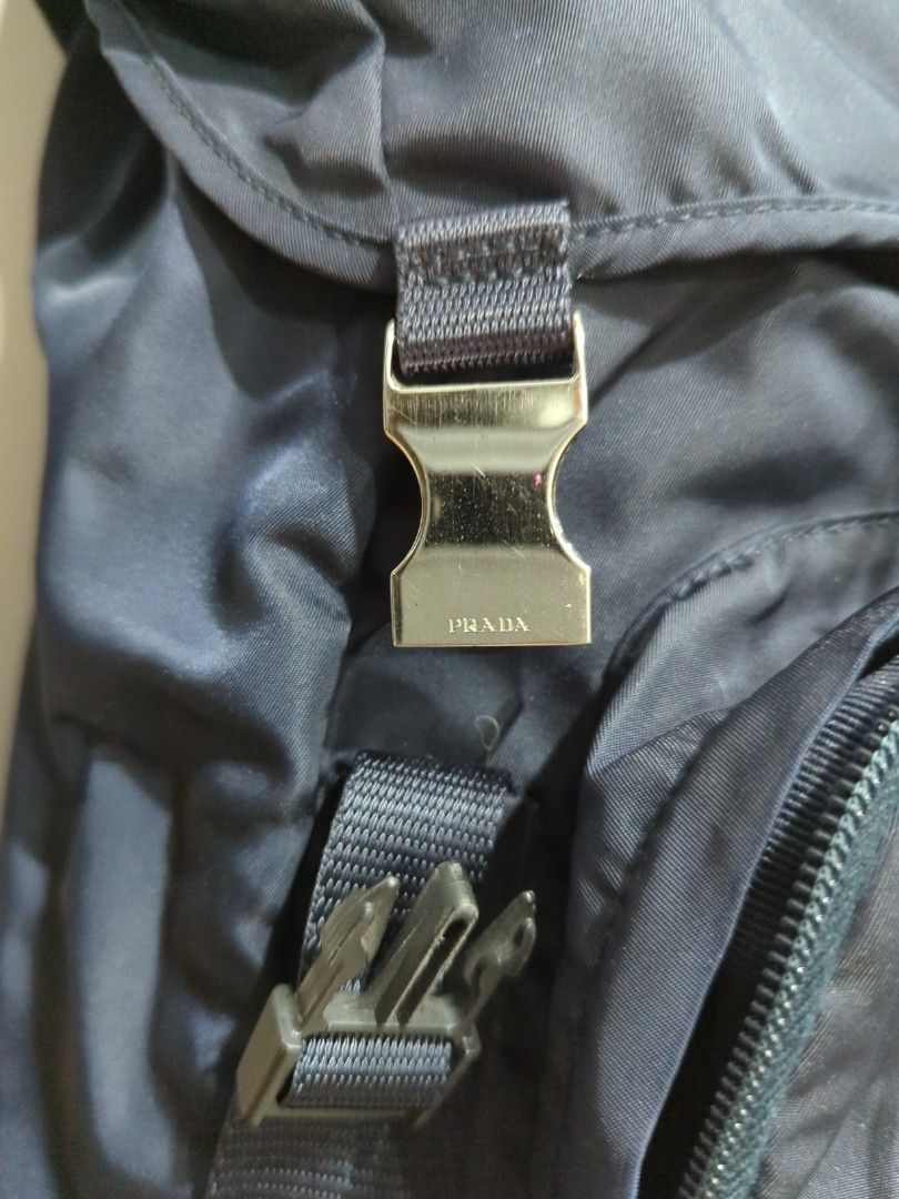 Prada backpack (Category: Bags & Wallets) located in Singapore. Submitted by altoh (Listing ID 1282892621, Image 3). Description: Lightly used Prada tessuto backpack in navy for sale. huge compartment with plenty of storage and the bag itself is super light. DIMENSION (L)27cm x (H)48cm x (W)12cm *note that there are 3 defects/tears on the flap on the cover (last 3 photos), hardly noticable unless you take a close look* interested buyers pickup at