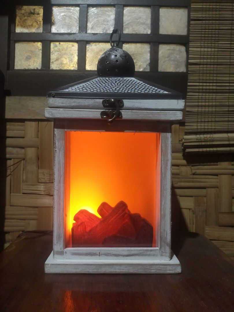 Hanging lamp (Category: Lighting) located in Quezon City. Submitted by dello5 (Listing ID 1283243513, Image 1). Description: Table/ Hanging Lamp -good condition -with 12volts power supply -can be hanged or in table top -7" x 7" base size -14" tall -wood & metal materials -light is moving like real fire -video can be requested if needed 950php Tandang Sora QC.