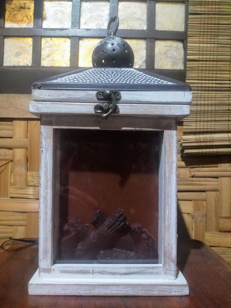 Hanging lamp (Category: Lighting) located in Quezon City. Submitted by dello5 (Listing ID 1283243513, Image 2). Description: Table/ Hanging Lamp -good condition -with 12volts power supply -can be hanged or in table top -7" x 7" base size -14" tall -wood & metal materials -light is moving like real fire -video can be requested if needed 950php Tandang Sora QC.