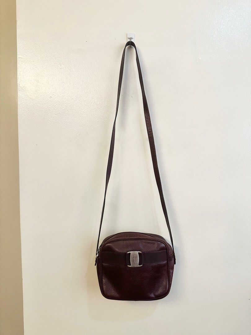 Dark maroon Ferragamo sling (Category: Luxury Bags & Wallets) located in Quezon City. Submitted by angshopper (Listing ID 1276564420, Image 2). Description: -well-loved, hardware are tarnished (they look silver) -spacious, good for an everyday sling bag -can fit phones and other essentials -7.5 x 6 x 2.5 inches, 21” drop.