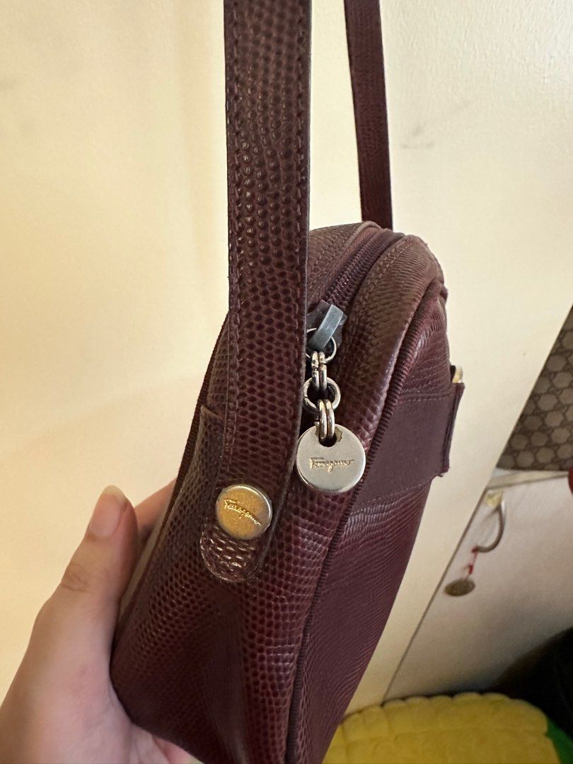 Dark maroon Ferragamo sling (Category: Luxury Bags & Wallets) located in Quezon City. Submitted by angshopper (Listing ID 1276564420, Image 3). Description: -well-loved, hardware are tarnished (they look silver) -spacious, good for an everyday sling bag -can fit phones and other essentials -7.5 x 6 x 2.5 inches, 21” drop.