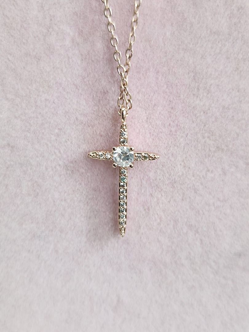 Gold and diamond cross outlet pendant
