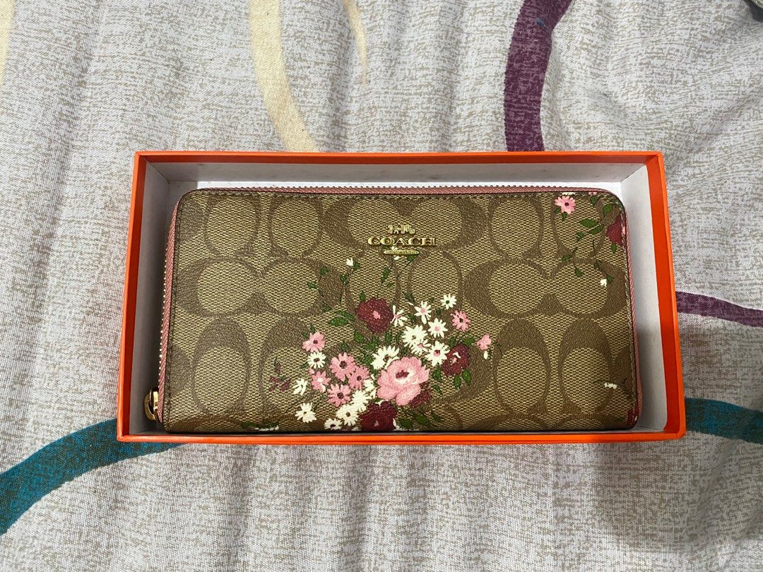 Authentic Coach Zip Around Wallet (Category: Luxury Bags & Wallets) located in Quezon City. Submitted by aki_dclttr (Listing ID 1277705420, Image 1). Description: authetic coach zip around wallet apricot and pink floral rfs: gifted to me but i dont use big wallets .
