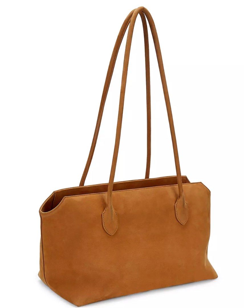 The Row Terrasse Suede Tote in Ginger (Category: Luxury Bags & Wallets) located in Rosario. Submitted by myvinatgepieces (Listing ID 1277709821, Image 1). Description: Authentic Ginger Color The Row’s Terrasse tote is crafted of smooth suede in a signature minimalistic design. Top zip closure Interior zip pocket Calfskin leather Made in Italy Good Used Condition Normal Signs of wear No Inclusions SIZE Dual shoulder straps, 13” drop 15.75”W x 7.75