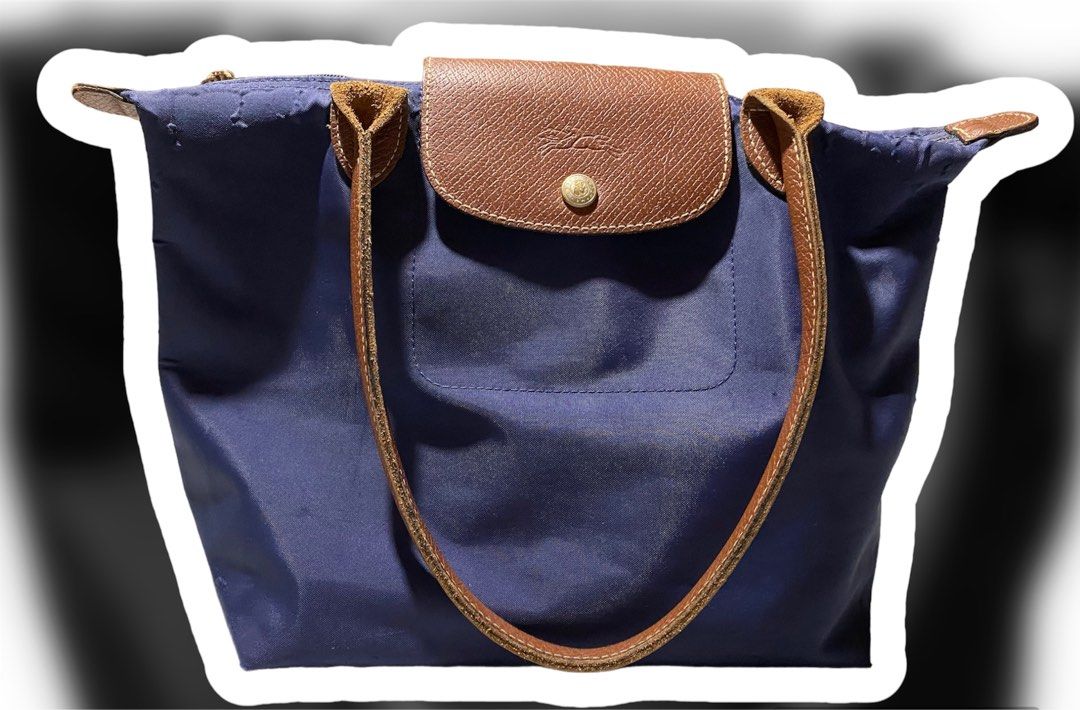 AUTHENTIC- Longchamp Le Pliage (Category: Luxury Bags & Wallets) located in Cabanatuan. Submitted by boo_121994 (Listing ID 1277995172, Image 2). Description: PreLoved - Authentic Longchamp Le Pliage Navy Blue in Small size. (Long hande) Bought it pre-order abroad. (Made in Paris) Rfs: Decluttering. Manage your expectation as it has been used, but not abused. Still presentable. *issue: last photos. *Note: This item is not Ukay. This is my persona