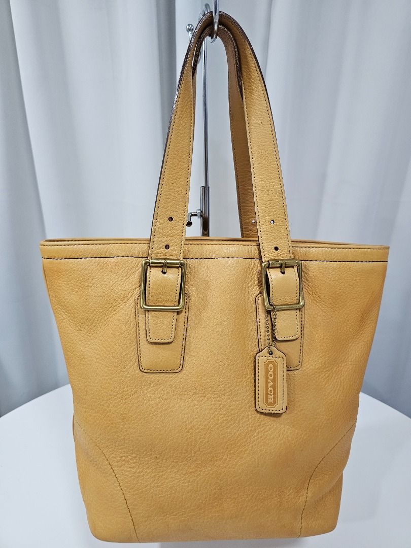 Coach Leather Vintage Tote Bag (Category: Luxury Bags & Wallets) located in Las Pinas. Submitted by mybagsfromthepast (Listing ID 1277899167, Image 1). Description: 100% Original Coach Leather Vintage Tote bag Yellow with beige undertone in gold hardware. Overall in good preloved condition (With minor signs of usage) Measurements (Approx) Width:14in Height:11in Depth:6in Top handle drop 8in Please manage your expectations when buying preloved ite