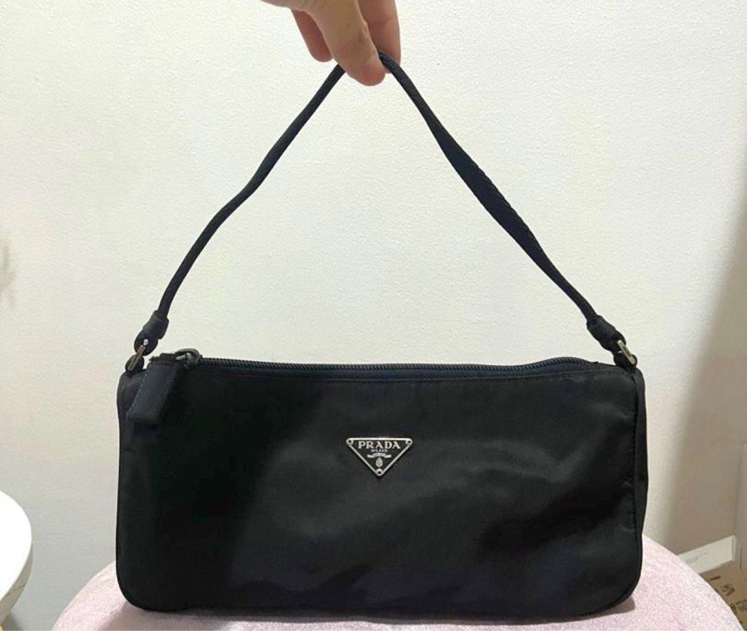 Prada Black Nylon Pochette Bag (Category: Luxury Bags & Wallets) located in Tarlac. Submitted by gonzkri (Listing ID 1278012754, Image 1). Description: Guaranteed authentic. Money back guaranteed. Seldom used. I will include a bag organizer inside for versatility..