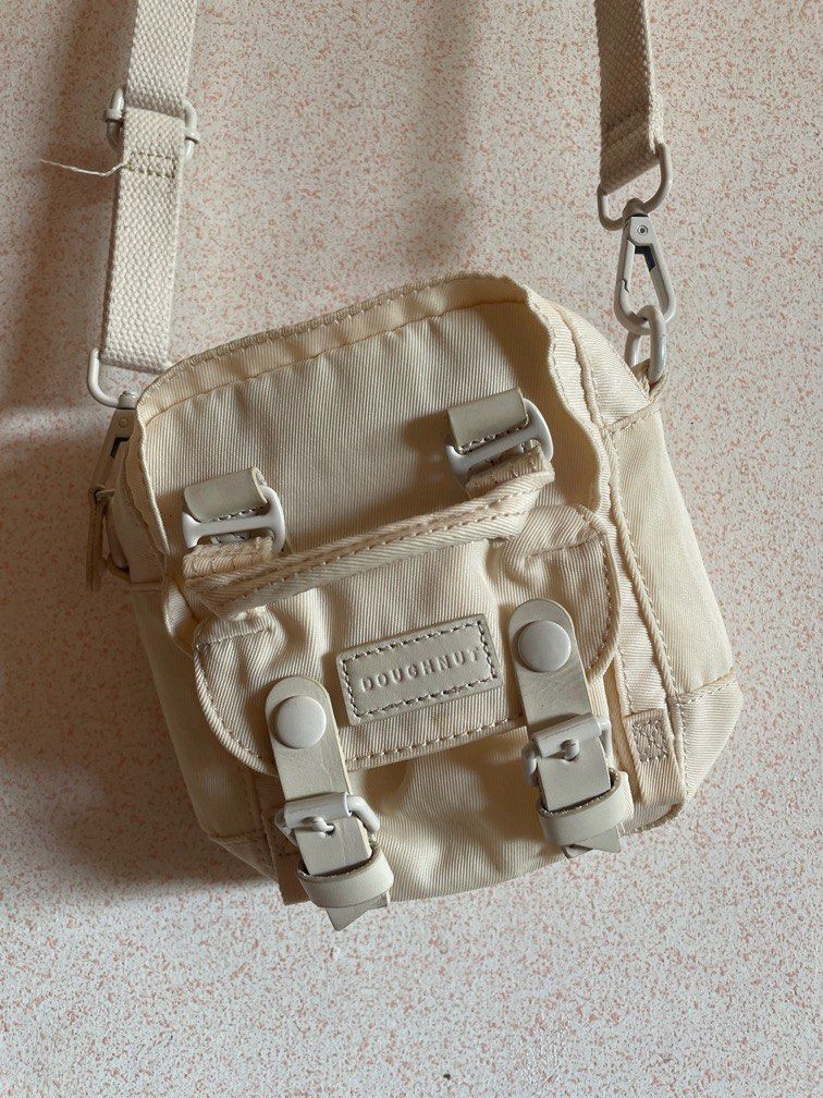 DOUGHNUT Tiny Macaroon Cream Color (Category: Cross-body Bags) located in Batangas. Submitted by declutter.btg.mnl (Listing ID 1328422501, Image 2). Description: Has slight discoloration, check photo RFS: need funds, also not using much, I prefer larger bags Bought this in Megamall :) I do prefer meet ups. USUALLY Megamall on weekends/Batangas area weekdays.
