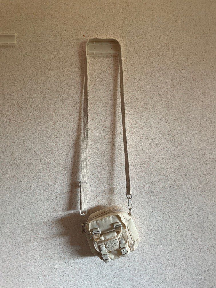 DOUGHNUT Tiny Macaroon Cream Color (Category: Cross-body Bags) located in Batangas. Submitted by declutter.btg.mnl (Listing ID 1328422501, Image 1). Description: Has slight discoloration, check photo RFS: need funds, also not using much, I prefer larger bags Bought this in Megamall :) I do prefer meet ups. USUALLY Megamall on weekends/Batangas area weekdays.