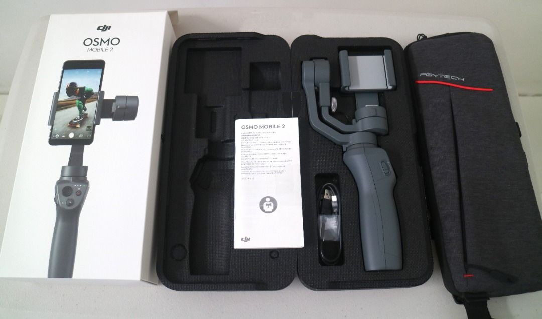 [Pre-Loved] DJI OSMO Mobile 2 (with box) (Category: Gimbals & Stabilizers ) located in Pasig City. Submitted by findingviolet (Listing ID 1328436326, Image 1). Description: [Pre-Loved] DJI OSMO Mobile 2 - The Osmo Mobile 2 is a handheld smartphone gimbal that helps you capture smooth, cinematic movement. Model: OM170 Condition: Like new with box, used with care RFS: seldom used, not really using it anymore For specs, you may check at https://www.