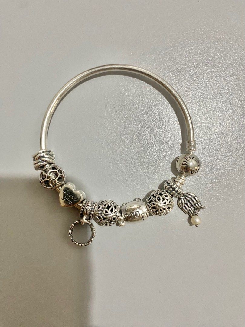 Pandora Moments Bangle with 7 charms (Category: Luxury Accessories) located in Cebu City. Submitted by second.scents (Listing ID 1330263160, Image 3). Description: Pandora Moments Bangle Free 7 Pandora bought charms Size 17 Polishing cloth never used Still comes with the box Reguarly cleaned by the Pandora Store Total store value: P24,000 .