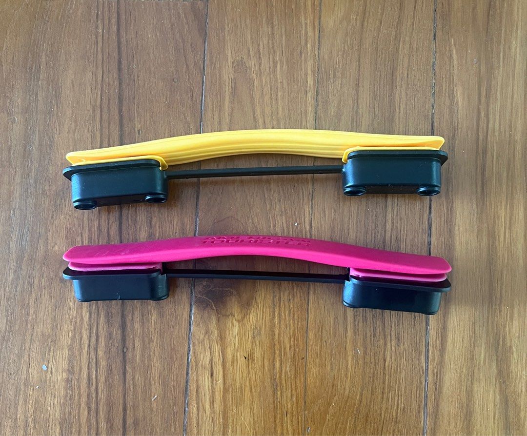 Spare parts Curio. American Tourister luggage. Wheels and handles. Pink and yellow