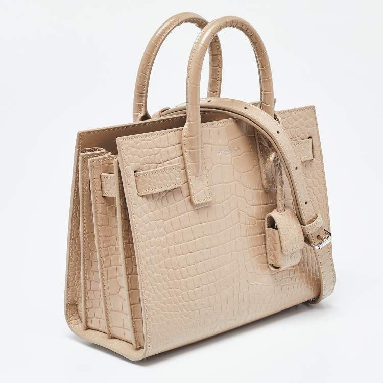 YSL Sac De Jour Small (Category: Luxury Bags & Wallets) located in Tagaytay City. Submitted by verycutesy8 (Listing ID 1330261117, Image 2). Description: All items are available unless marked as sold or reserved. Super sale today YSL Sac de jour in beige patent Croc Embossed Leather Nano, silver hardware, coded, comes with a dustbag. This is super nice and classy in person. .