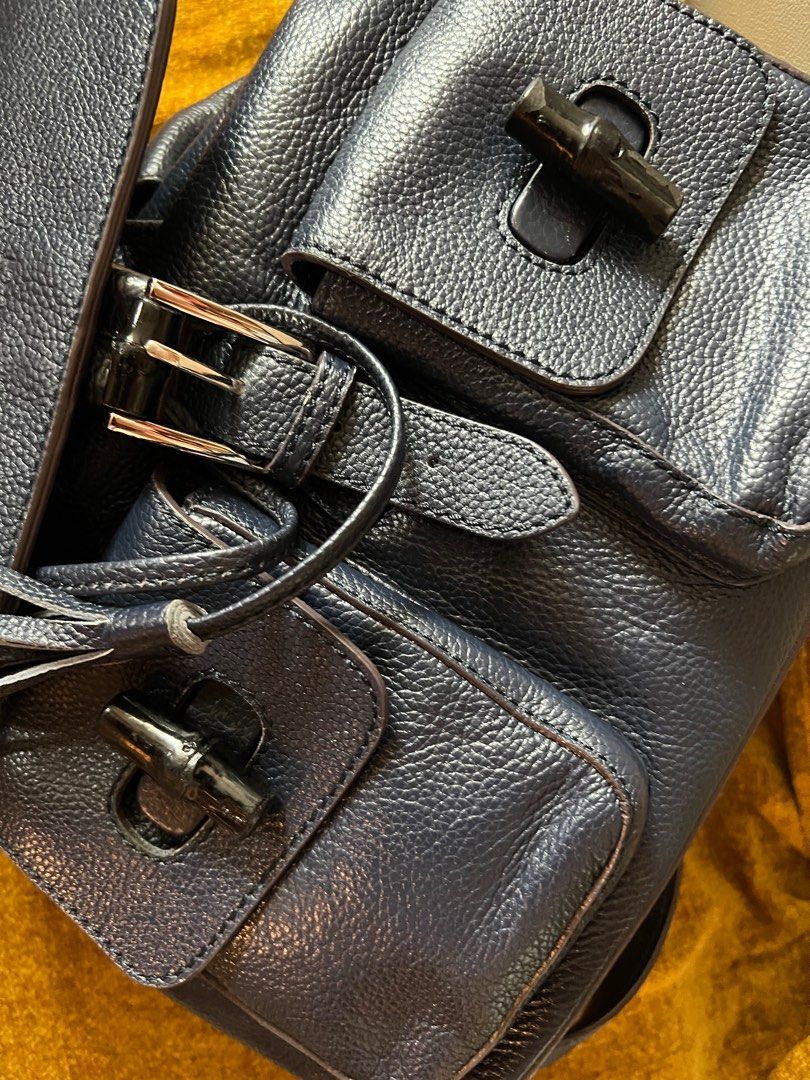 Gucci Bamboo Backpack (Category: Luxury Bags & Wallets) located in Manila. Submitted by ladybagmnl (Listing ID 1330344123, Image 3). Description: Inclusions: Generic Dustbag Material: Leather Color: Dark Blue Size: Base length: 12.00 in Height: 11.75 in This piece features cowhide leather exterior front pocket flaps with bamboo turn locks, cowhide shoulder straps, and a bamboo top handle with polished silver hardware. The top flap opens by tassel