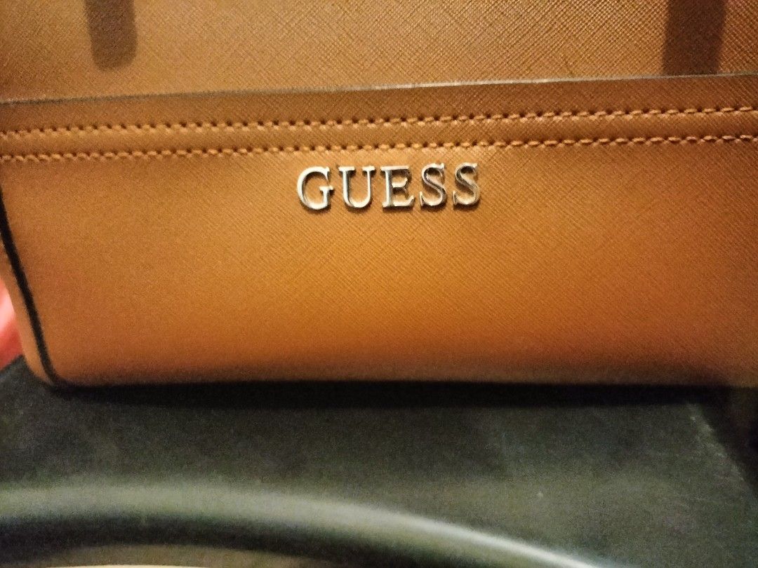 Guess Brown Tote (Category: Tote Bags) located in Paranaque City. Submitted by surfacedesign (Listing ID 1330504449, Image 1). Description: Authentic Guess Tote. Used once. Selling the bag because I am getting a smaller bag. My location is in Manila. PM if interested. Shipping shouldered by buyer.