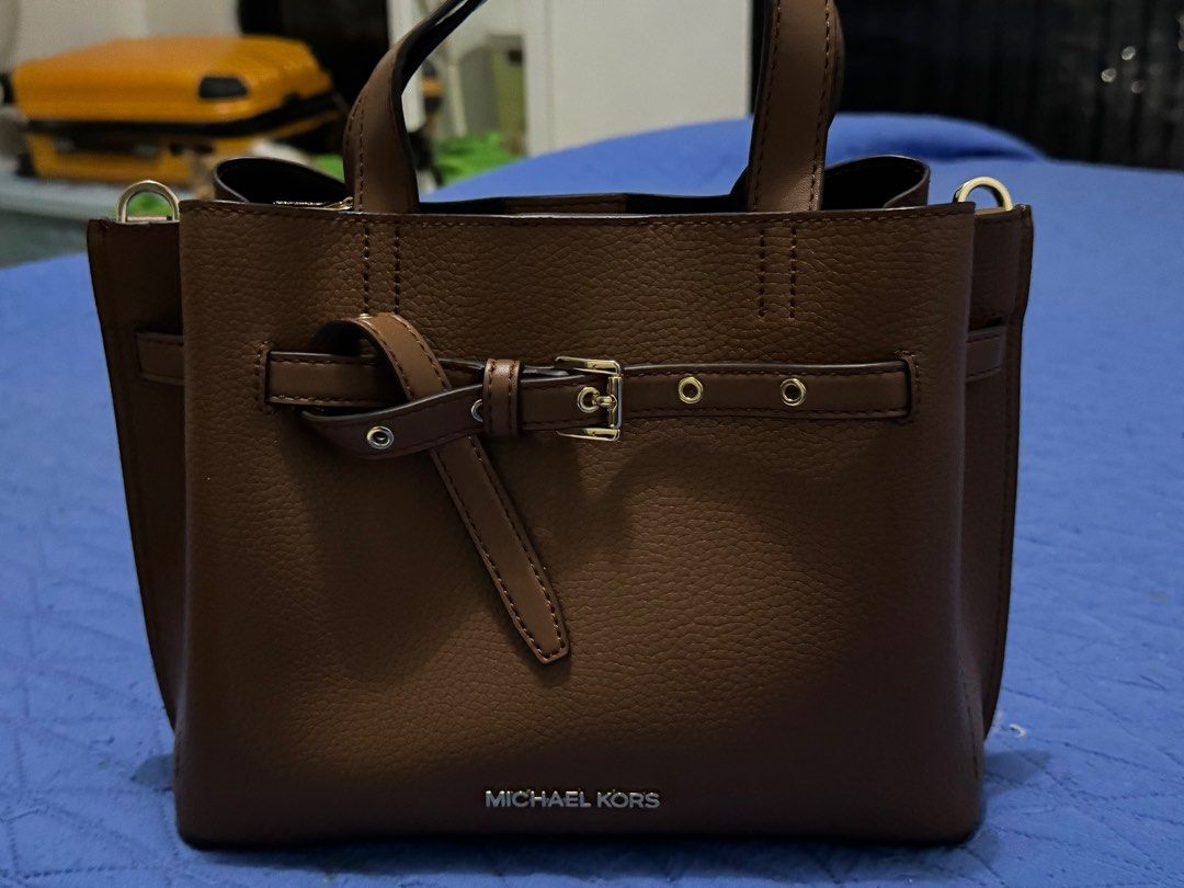 Michael Kors Emilia sling bag (Category: Luxury Bags & Wallets) located in Pasig City. Submitted by solelypreloved (Listing ID 1312236896, Image 2). Description: Color brown Looks new Authentic Mk Last price. No haggling • 100% leather from tanneries meeting the highest standards of environmental performance • Satchel • Pebbled leather • 100% leather • Gold-tone hardware • 10.75”W X 8”H X 5”D • Handle drop: 3.75” • Adjustable straps: 18”-22” • In