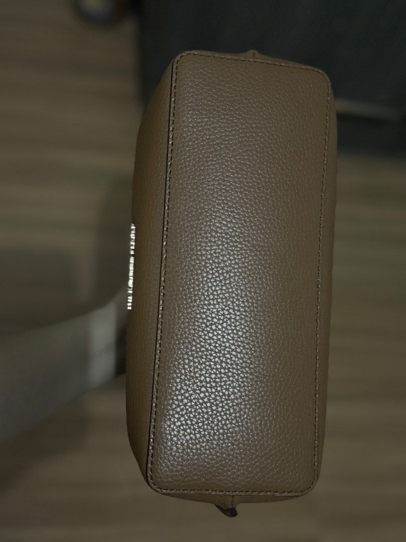 Michael Kors Emilia sling bag (Category: Luxury Bags & Wallets) located in Pasig City. Submitted by solelypreloved (Listing ID 1312236896, Image 3). Description: Color brown Looks new Authentic Mk Last price. No haggling • 100% leather from tanneries meeting the highest standards of environmental performance • Satchel • Pebbled leather • 100% leather • Gold-tone hardware • 10.75”W X 8”H X 5”D • Handle drop: 3.75” • Adjustable straps: 18”-22” • In
