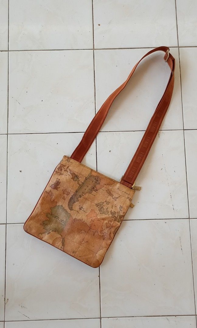 Alivero Martini Map sling bag (Category: Luxury Bags & Wallets) located in Bacolod City. Submitted by arvene_jan (Listing ID 1330579233, Image 1). Description: Alviero Martini 11" length 11 width 9.8/10 condition, no issues mine for only 2500 plus sf via J&T message me 📩.