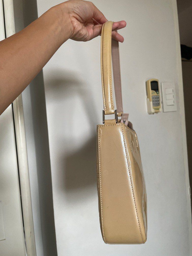 Ungaro Patent Leather Shoulder Hobo Bag (Category: Shoulder Bags) located in Cavite. Submitted by xsybear (Listing ID 1330532479, Image 3). Description: 🖤 Ungaro - French brand 🫶🏼 🖤 Very good condition! 🖤 Super nice in actual ✨ Parang di nagamit 🥹 🖤 Pastel / Butter yellow color 🖤 Shiny silver hardware 🖤 Embossed monogram RFS: Downsizing my bag collection .