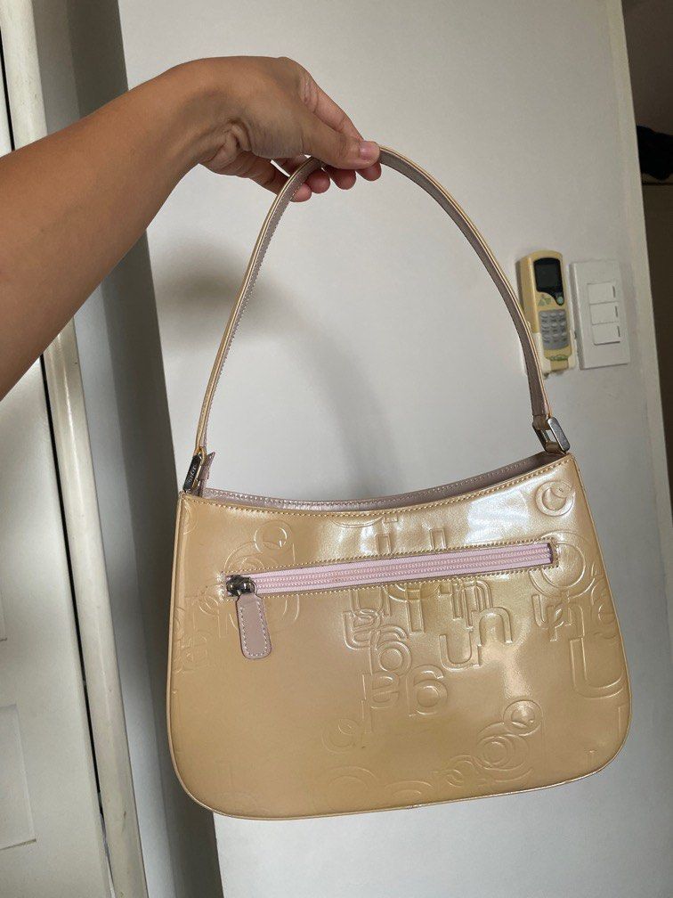 Ungaro Patent Leather Shoulder Hobo Bag (Category: Shoulder Bags) located in Cavite. Submitted by xsybear (Listing ID 1330532479, Image 2). Description: 🖤 Ungaro - French brand 🫶🏼 🖤 Very good condition! 🖤 Super nice in actual ✨ Parang di nagamit 🥹 🖤 Pastel / Butter yellow color 🖤 Shiny silver hardware 🖤 Embossed monogram RFS: Downsizing my bag collection .