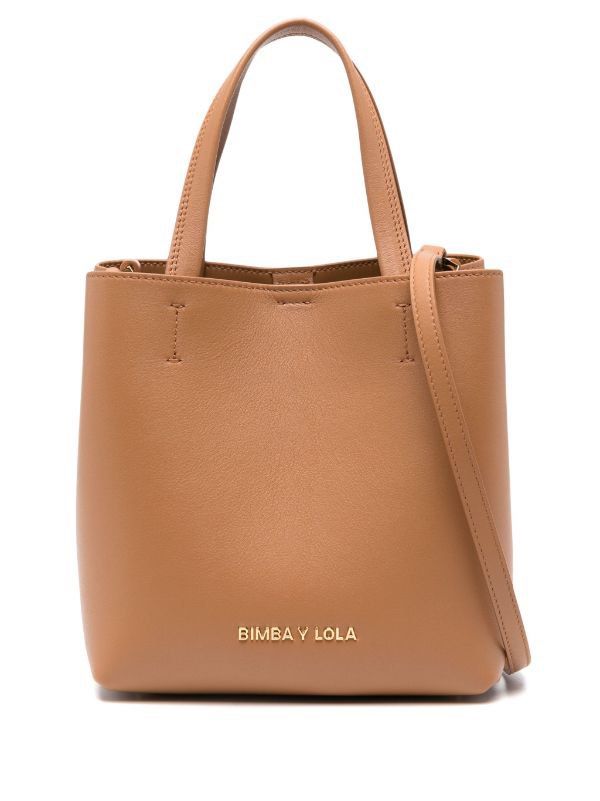 BIMBA Y LOLA Small Honey Leather Chihuahua Bag (Category: Tote Bags) located in Singapore. Submitted by peachesclub (Listing ID 1330780462, Image 1). Description: Great condition, no defects. Leather Chihuahua handbag in honey. Small model with snap fastener, two handles, long adjustable leather strap and interior pocket with zip. Exterior customized with metallic logo. Color: Honey Approximate measurements: 15 x 20 x 14 cm.