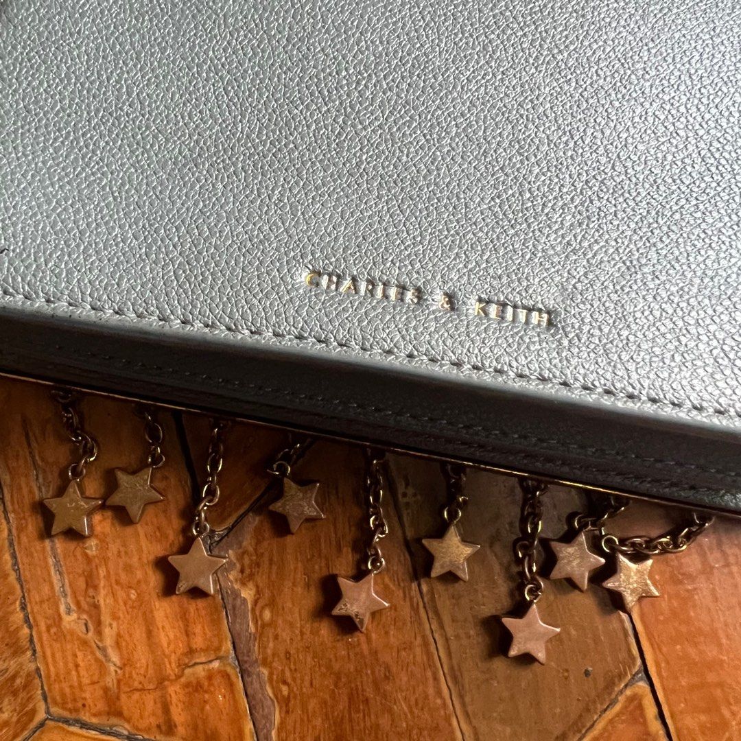 Charles & Keith Blue Charm Detail Bag (Category: Cross-body Bags) located in Quezon City. Submitted by naomenv (Listing ID 1330749840, Image 2). Description: - Color may vary slightly due to lighting (most accurate color is shown in 1st photo) - Bought from a thrift shop in the same condition posted (for about ~₱800) - Worn only once - Star charms have rust or are tarnished - Crossbody chain still in great condition - Negotiable - Message for mor