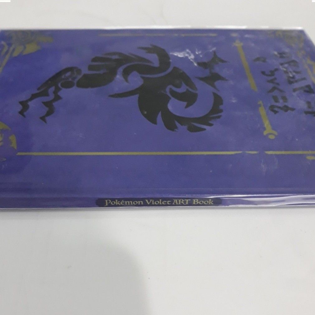 Pokemon Violet Artbook [VIOLET BOOK] (Category: Nintendo) located in Daraga. Submitted by namikazeloves (Listing ID 1331005657, Image 3). Description: ☆Selling [Pokemon Violet Artbook [VIOLET BOOK]] FOR SALE ONLY☆ ●Included in the Pokemon Center Japanese pre-order. An imitation hard book just like the "VIOLET BOOK" Key Item in Pokemon Violet in-game. There are several artworks inside like Paldea Geography, Pokemon Designs, and Character Designs. 