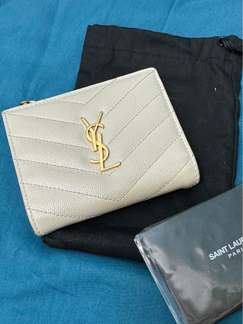 SUPER SALE!!! YSL Compact Wallet (Category: Luxury Bags & Wallets) located in Taguig. Submitted by anniething.goes (Listing ID 1331168632, Image 1). Description: Excellent condition 9/10 Bifold with bills and coin compartment Off white, GHW Comes with dustbag and cards Selling low!!! All sales are final‼️ No joy reservers‼️ No low ballers‼️ All sales are final, no return no exchange no refund unless proven fake‼️.