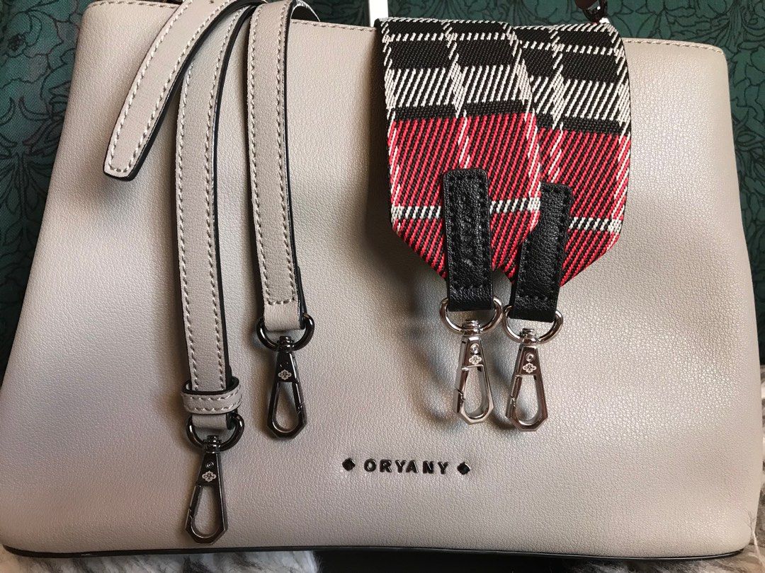 Brand new Oryany Bag with 3 straps (Category: Luxury Bags & Wallets) located in Muntinlupa City. Submitted by rina.rina3 (Listing ID 1331426803, Image 3). Description: Oryany 3-in-1 bag complete with 3 straps - checkered red guitar strap, slim strap and short strap Sourced from Korea Nude, super pretty and sturdy in person Very lightweight Excellent gunmetal hardwares Bag dimensions in inches, LXWXH 11.5in (base) x 4.5in (base) x 7.75in Buyer to 