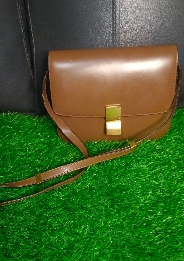 Celine box sling bag (Category: Luxury Bags & Wallets) located in Legazpi City. Submitted by georgepineda791 (Listing ID 1331553851, Image 1). Description: Preloved Celine Box Sling Bag made of durable, hard leather with gold hardware and a code inside the pocket. Can be worn as a shoulder or crossbody bag. It shows very minimal signs of usage. There are some pressed marks on the rubber linings and a few areas, but they’re not noticeable unless c