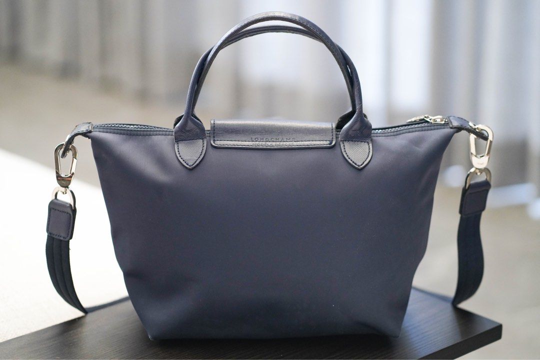 Longchamp Le Pliage Neo - Navy Blue (Category: Luxury Bags & Wallets) located in Angeles City. Submitted by mkp125 (Listing ID 1331409994, Image 3). Description: - authentic - well-loved bag so the leather at the edges has signs of use, will look better if cleaned further - 25x23x16 cm - has some molds inside but can still be cleaned (last photo) - price reflects condition but the zipper, hardware, and bag exterior is in good condition - payment 