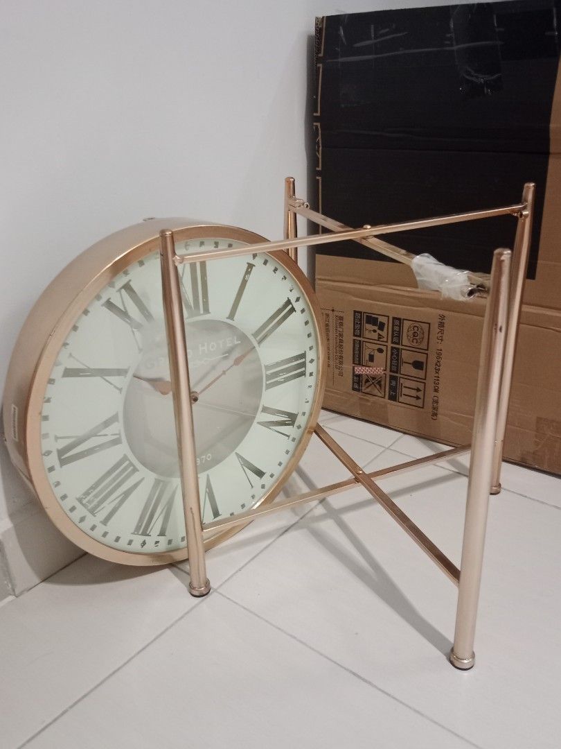 Table Clock (Category: Clocks) located in Kuala Lumpur. Submitted by creative_criteria (Listing ID 1328727637, Image 2). Description: - Size: 46cm (Diameter) x 47cm (Height) - Material: Metal + Glass Surface - Color: Gold + White + Silver - Can use as table, clock or deco depend on your creativity.