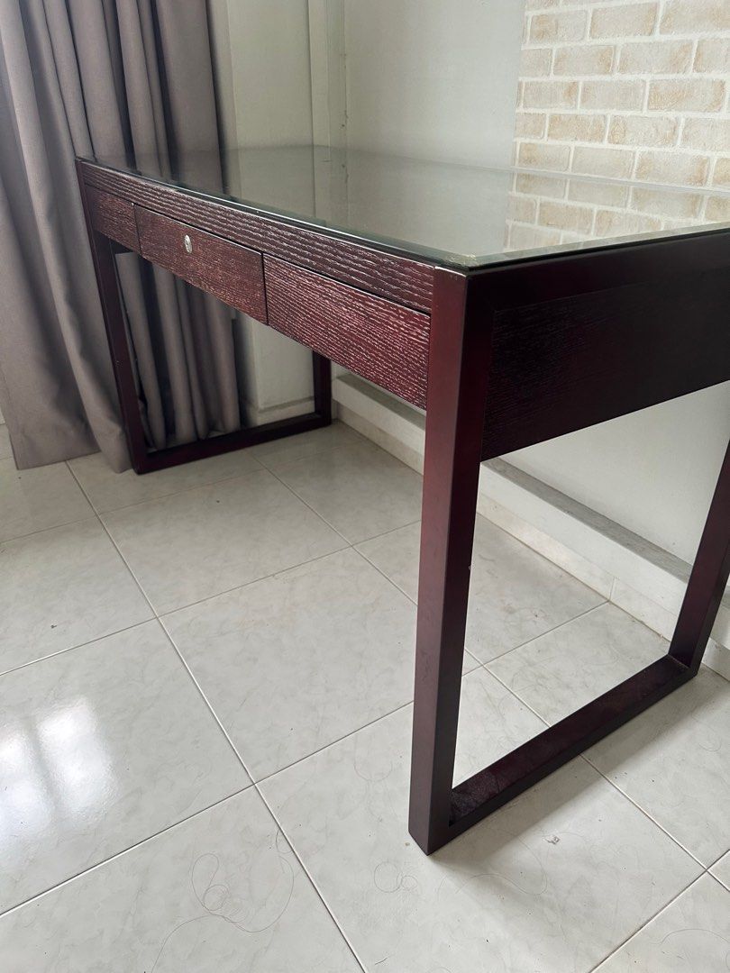 Study table (Category: Tables & Sets) located in Singapore. Submitted by the_arc (Listing ID 1331847671, Image 1). Description: Super condition and solid wood study table with glass table top Selling at $80 Need van and trolley Preferable with 2 man carry. Depth 23 inches Length 51 inches Height 30 inches .