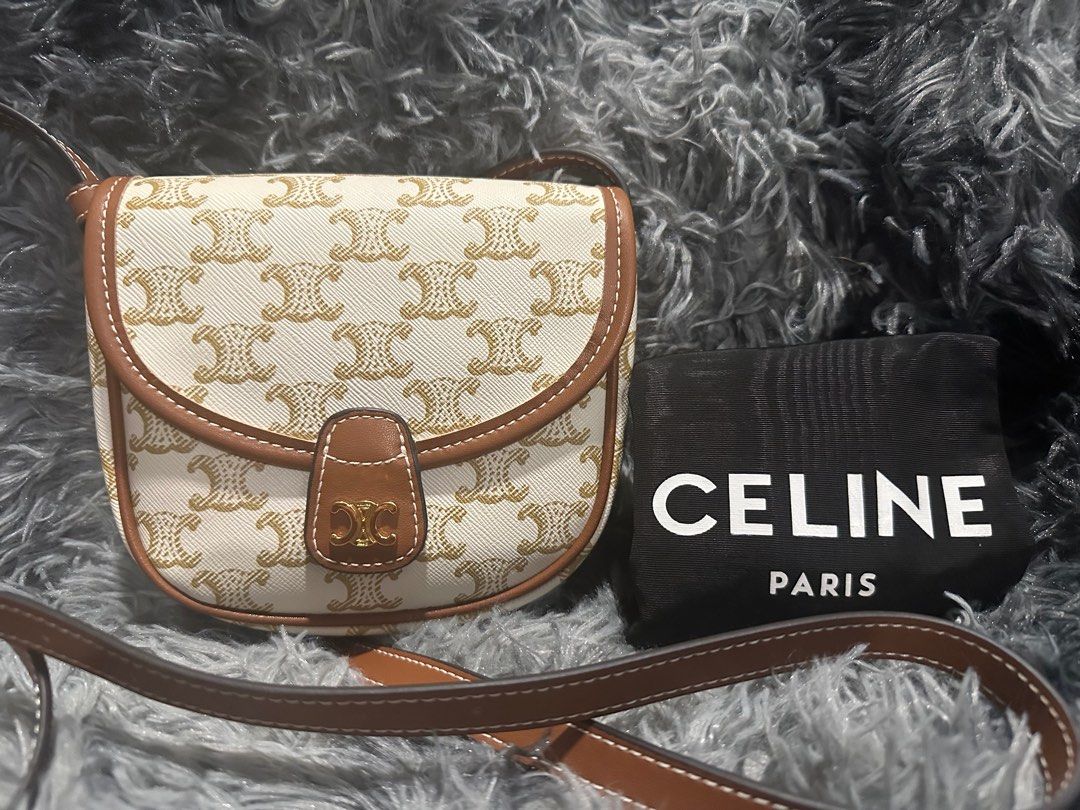 Triomphe Canvas Calfskin Mini Besace Bag White (Category: Luxury Bags & Wallets) located in Bayambang. Submitted by bagaholic_co (Listing ID 1332401541, Image 1). Description: GENUINE LEATHER Kasya iphone pro Base length: 6.00 in Height: 5.25 in Width: 1.50 in Drop: 22.50 in NO FLAWS CODED Japan-sourced This is a CELINE Triomphe Canvas Calfskin Mini Besace Bag in White. This chic bag is crafted of fine white coated canvas with brown leather trim.