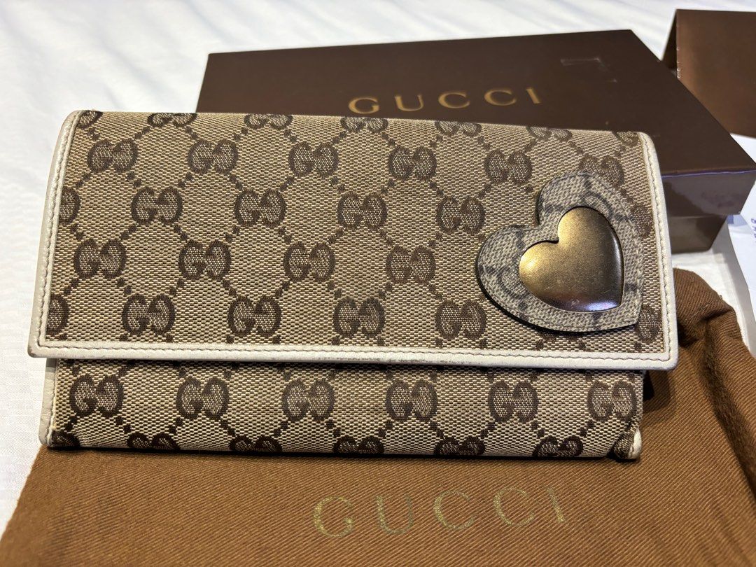 Authentic Gucci GG Canvas Long Waller (Category: Luxury Bags & Wallets) located in Guiguinto. Submitted by positivemind (Listing ID 1332476762, Image 2). Description: Package includes: Gucci Wallet, Dust Bag, Box, Receipt in the Gucci Envelope, Gucci Desiccant Gel, Gucci Product Care Booklet and other tags. No more paper bag. ISSUE: The interior leather has slightly shrunk due to water exposure. Please refer to the attached photos. Wallet was lig